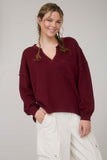 Split Neck Raw Edge Long Sleeve Ribbed Knit Top